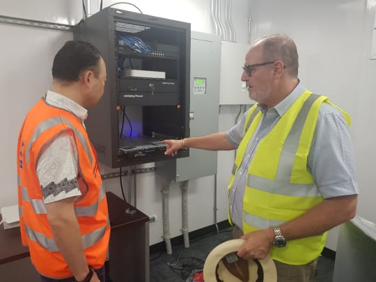 Solomon Islands Submarine Cable Company CEO, Keir Preedy, describing the Cable Landing Station equipment to DFAT Project Head, Pablo Kang (Credit: DFAT)